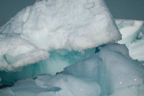 Free Detailed photograph of ice formations showcasing textures and blue hues in a natural setting. Stock Photo