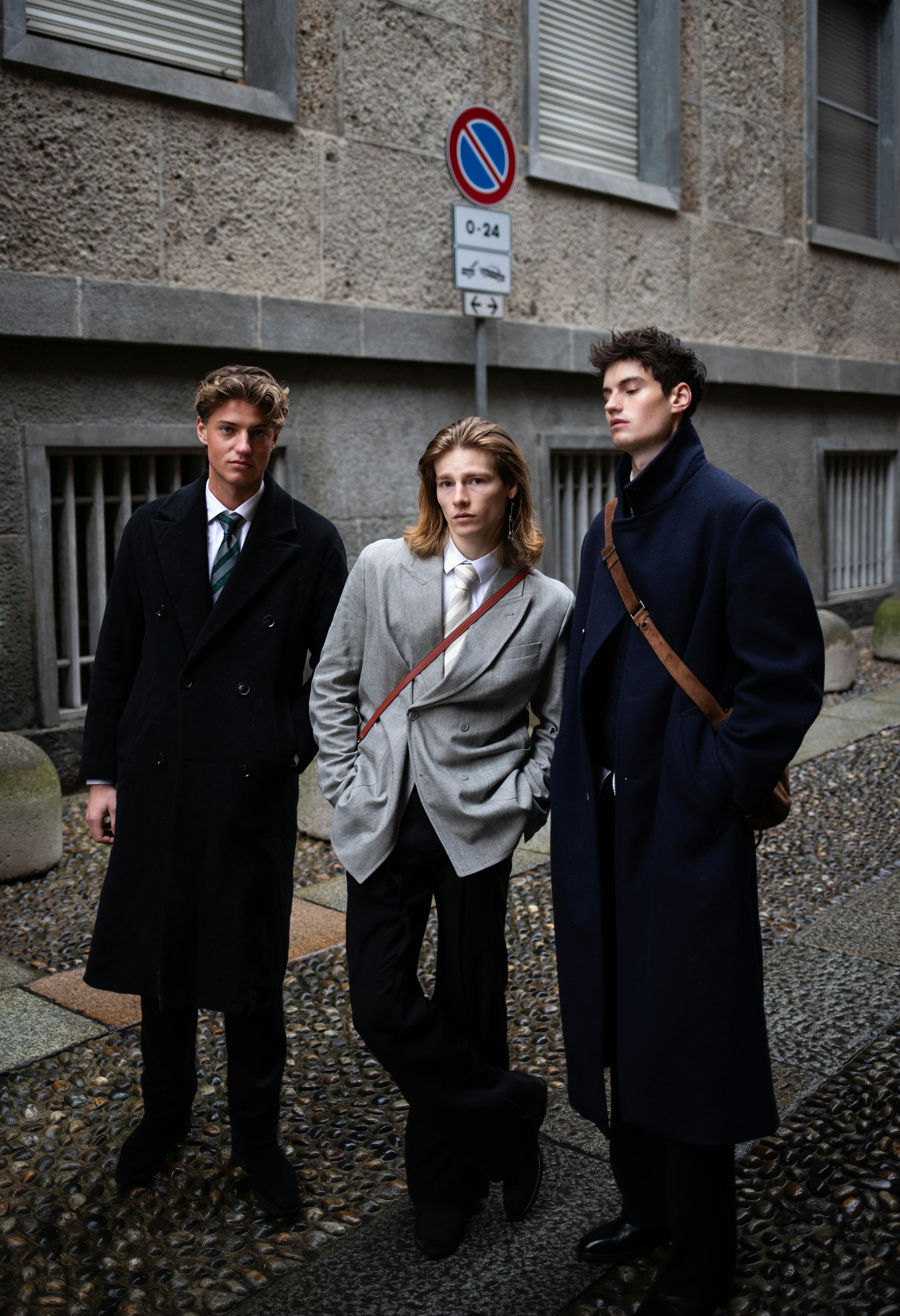 Three men showcasing elegant street fashion in Milano, Italy, with distinct winter style.