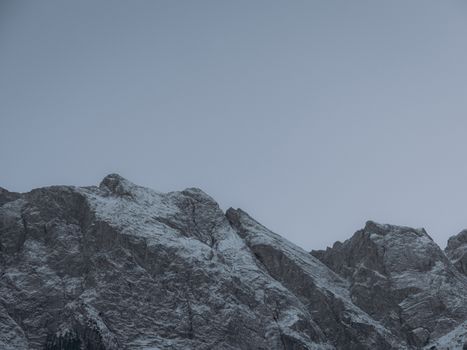 Majestic snow-covered mountain peaks under a clear winter sky.