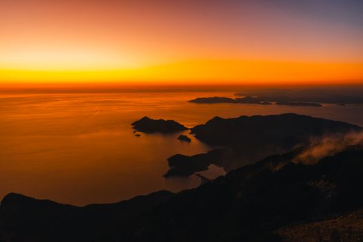 Breathtaking aerial view of a vivid sunset over the Fethiye coastline, Turkey.