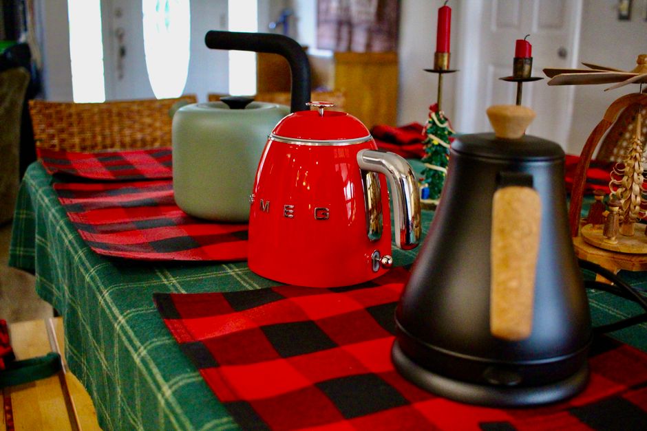 A cozy indoor setting featuring decorative kettles and festive table decor.