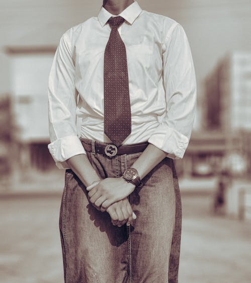 Free Person in casual business attire posing outdoors with a sepia tone effect. Stock Photo