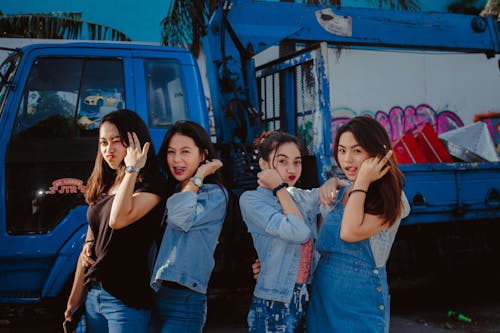 Free Young Women In Casual Wear Standing In Front Of A Truck Stock Photo