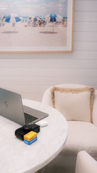 Elegant home office setup with beach-themed wall art. Relaxing and inspiring workspace.