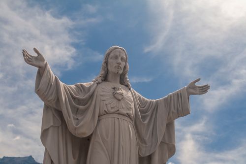 Free Impressive Sacred Heart of Jesus statue in Mérida, Venezuela, under a bright blue sky. Stock Photo
