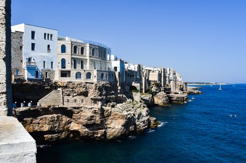 Free Beautiful cliffside view of Polignano a Mare, Italy with blue sea and sky. Stock Photo