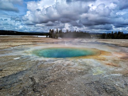 Free A stunning hot spring with vibrant colors and steam at Yellowstone National Park. Stock Photo