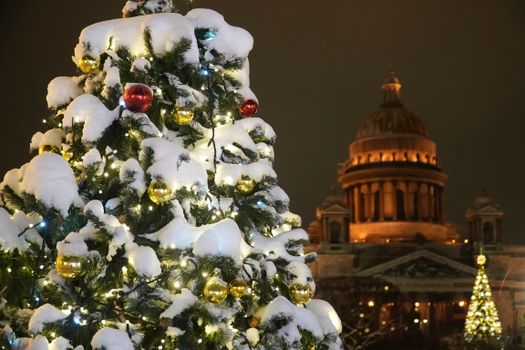 Festive Christmas tree adorned with baubles and lights near St. Isaac's Cathedral, Saint Petersburg.