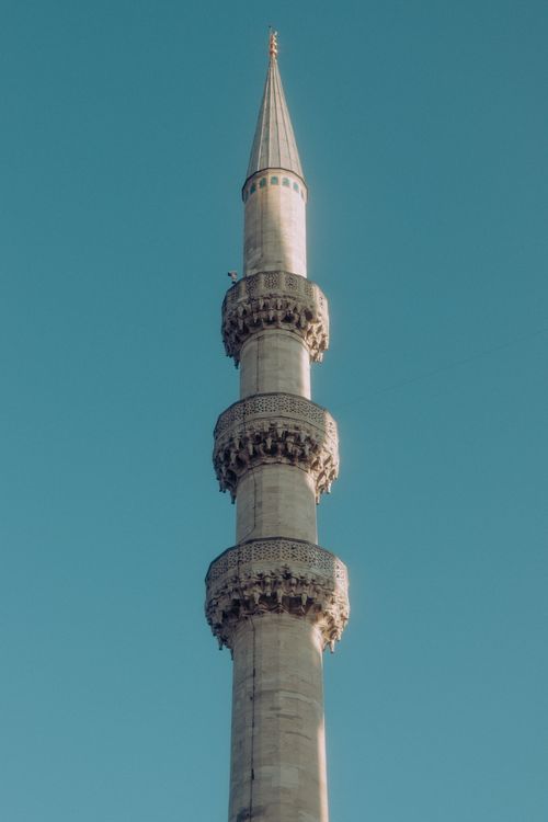Free Elegant minaret showcasing Islamic architecture against a clear sky, perfect for tranquility themes. Stock Photo