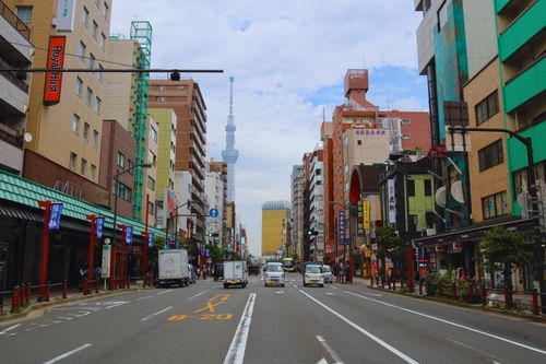 Free Vibrant street view in Tokyo with Skytree tower and bustling activity, capturing urban life. Stock Photo
