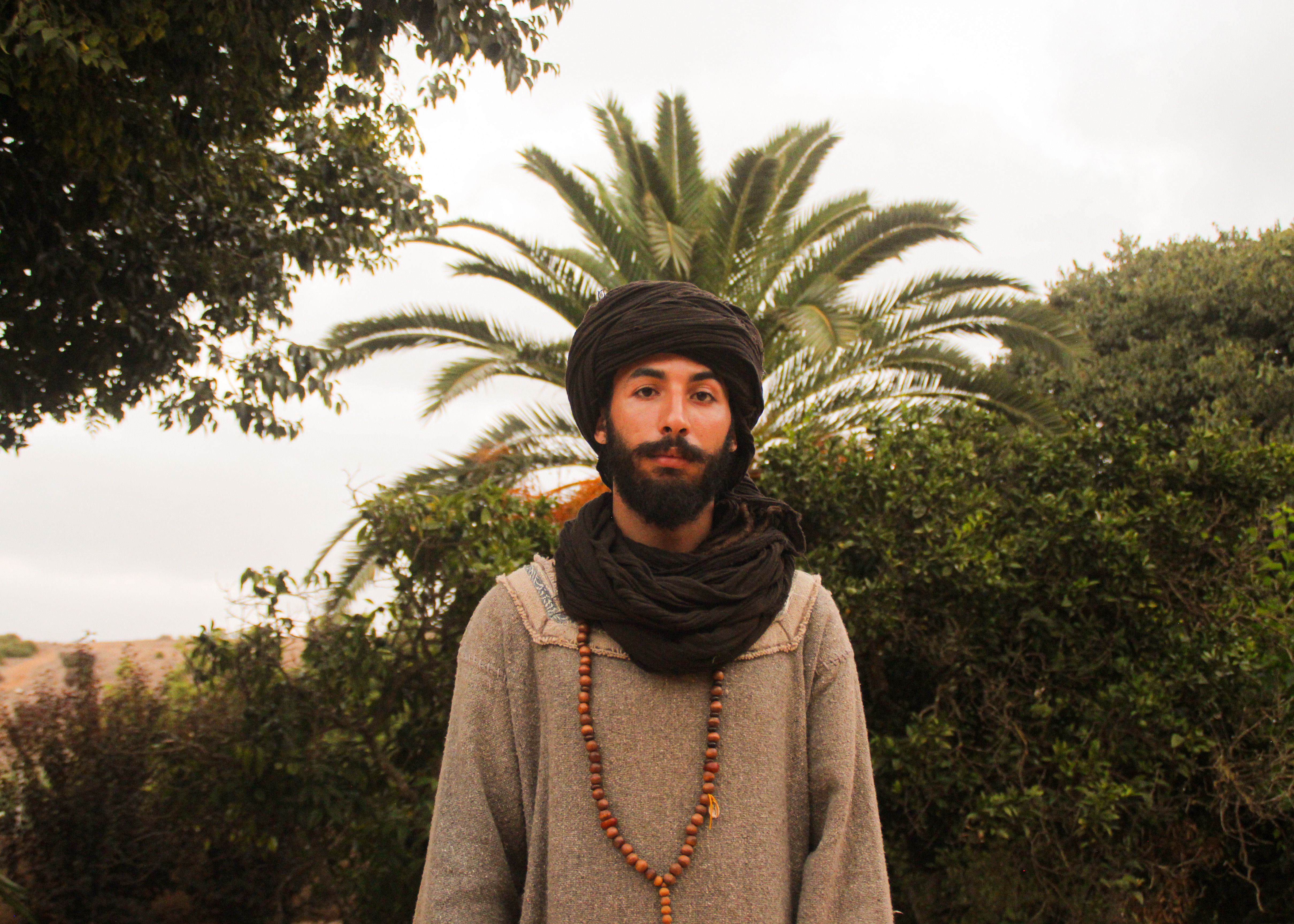 hombre-tradicional-marroqu-bajo-una-palmera-foto-de-stock-gratuita
