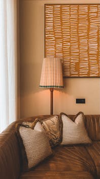 Warm boho living room in Barcelona with textured pillows and artistic wall decor.