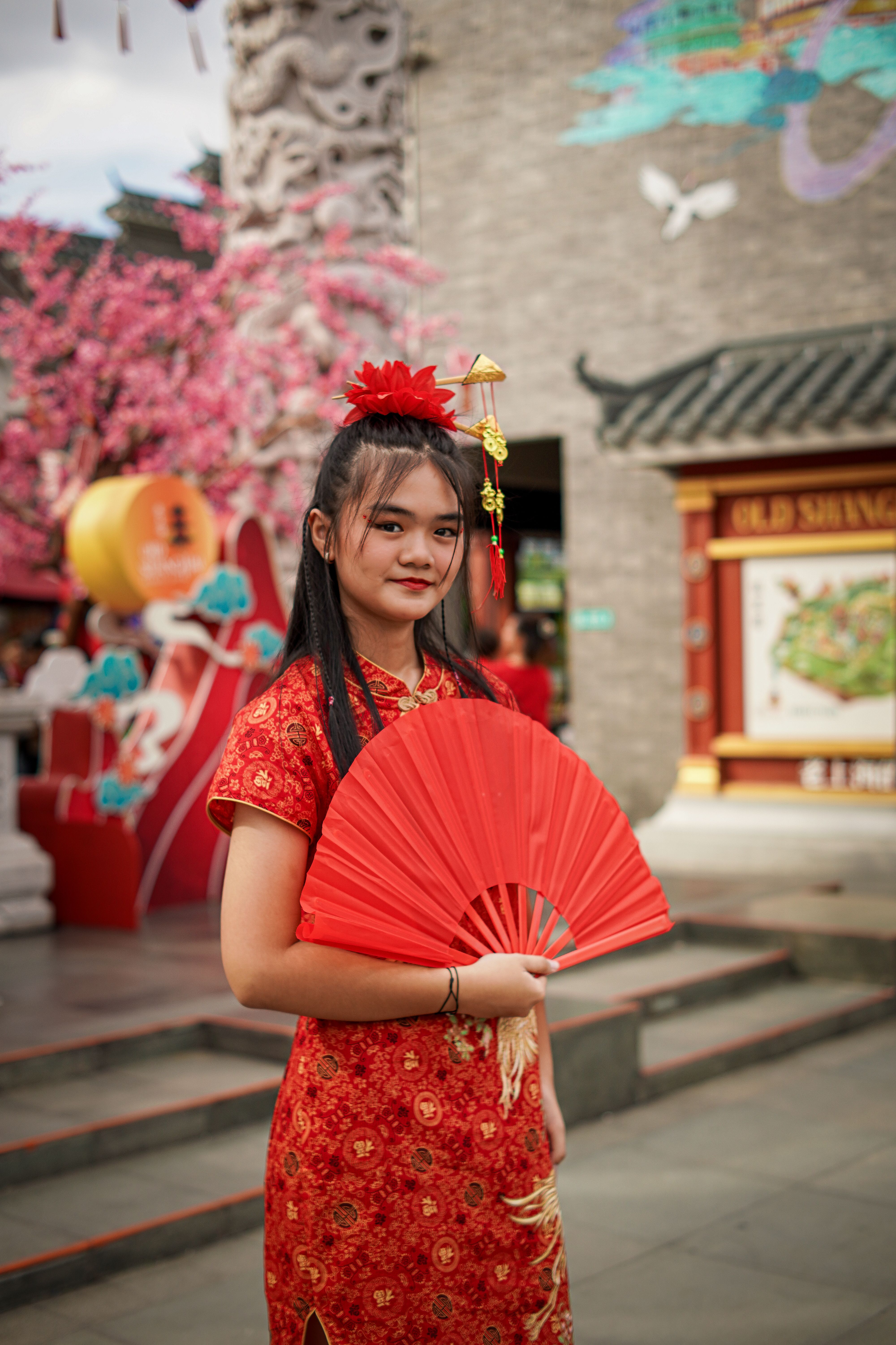 Young Woman in Red Dress with Fan in Jakarta · Free Stock Photo