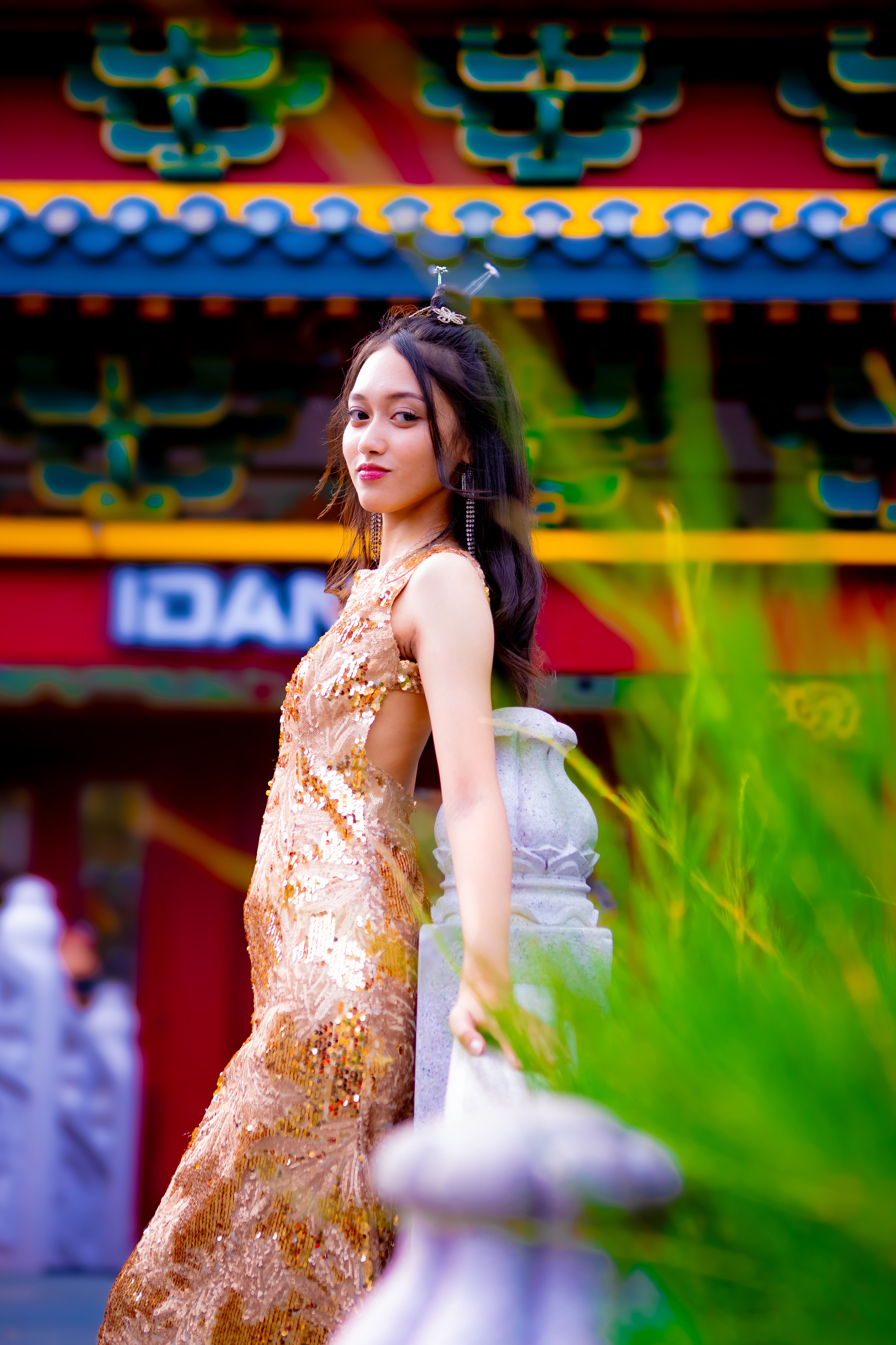 Elegant Woman in Gold Dress at Jakarta Temple  Free Stock Photo