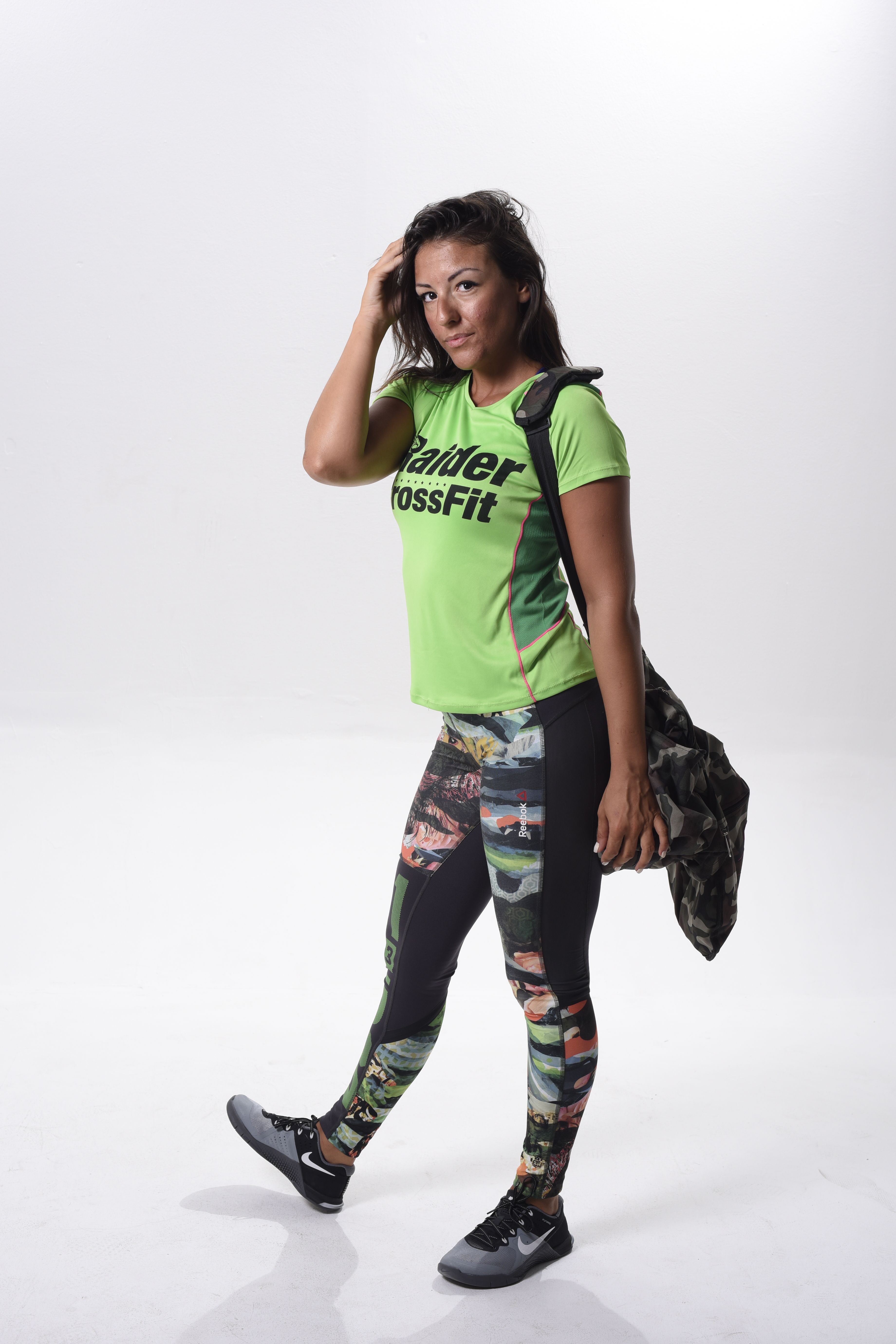 Fit woman poses confidently in trendy CrossFit apparel, showcasing strength and style.