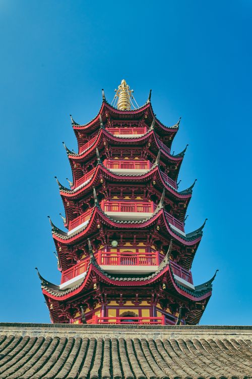Free Beautiful red Chinese pagoda with intricate architecture set against a clear blue sky. Stock Photo