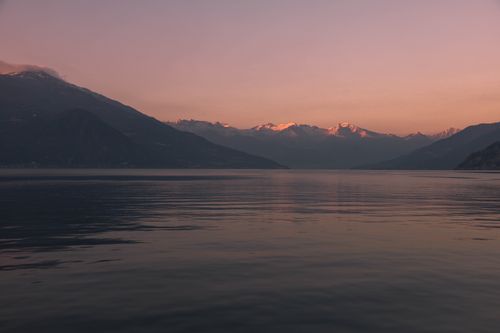 Free Serene sunset over Lake Como with mountains in the background, Italy. Stock Photo