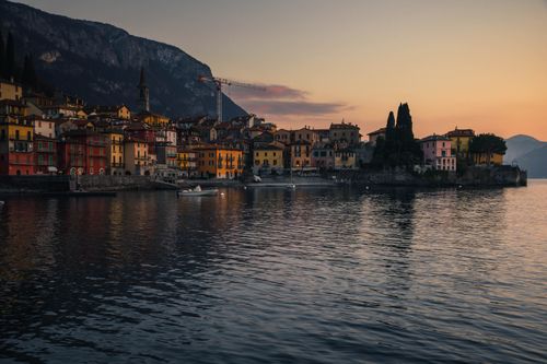Free Beautiful sunset view of Varenna along Lake Como, Italy, highlighting colorful architecture. Stock Photo