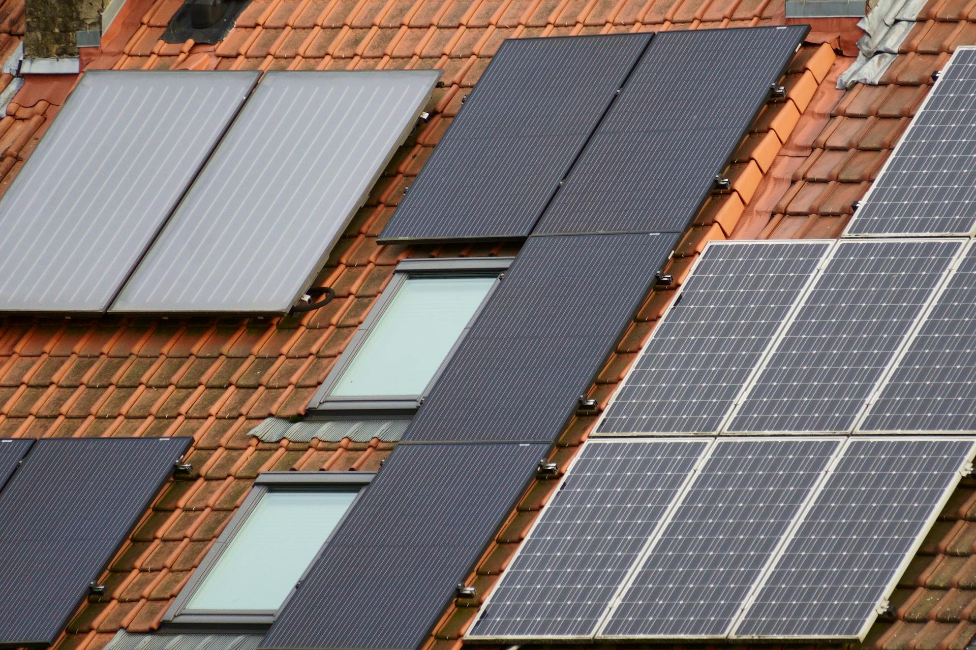 Close-up of solar panels on a tiled roof, showcasing sustainable energy solutions.