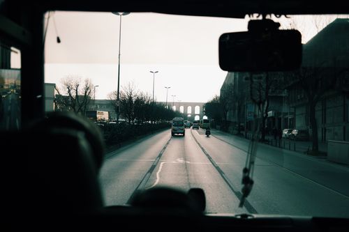 Free Captured view of city street through a vehicle window during daylight. Stock Photo