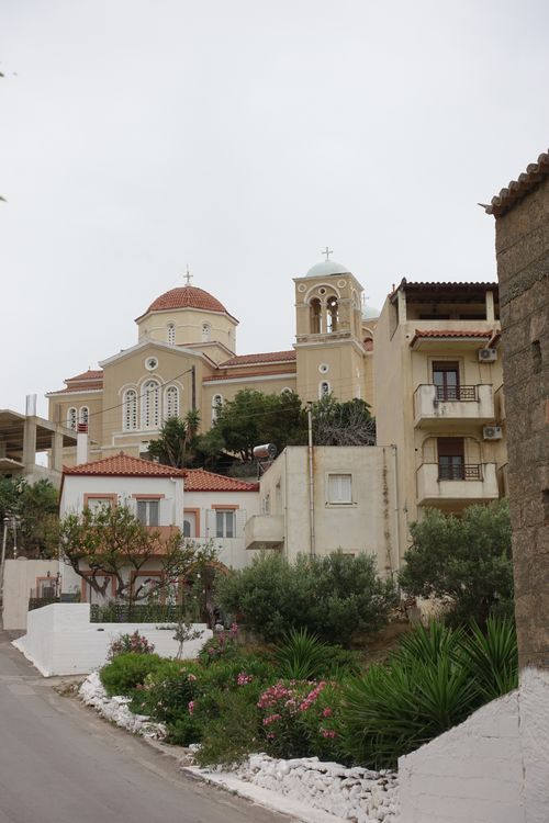 Free A scenic view of a traditional Mediterranean church with lush greenery in Greece. Stock Photo