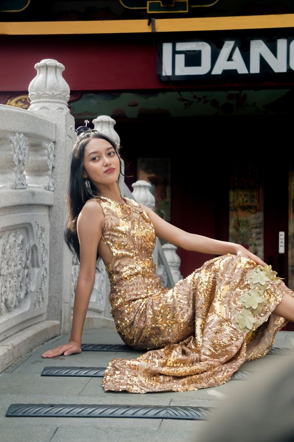 Woman wearing a gold brocade party dress