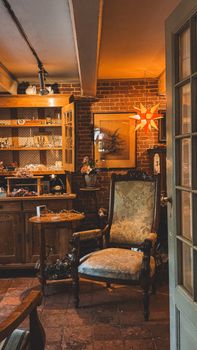 A charming vintage room featuring an antique armchair and warm ambient lighting, creating a cozy atmosphere.