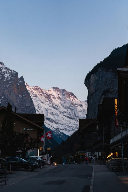 Free Twilight view of Lauterbrunnen village with Swiss Alps backdrop, showcasing snow-capped peaks. Stock Photo