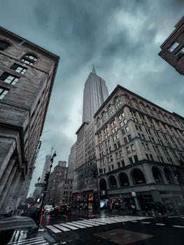 Stunning view of the Empire State Building surrounded by dramatic clouds in New York City.
