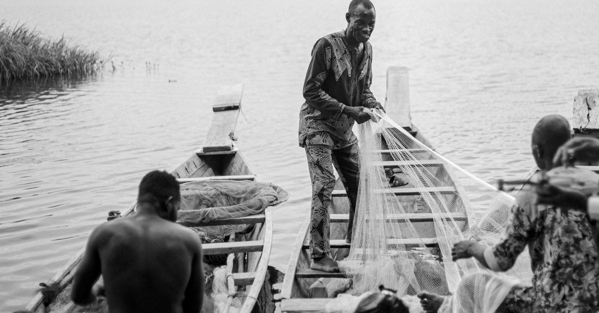 Sunset over the Volta Lake with a fisherman in a canoe