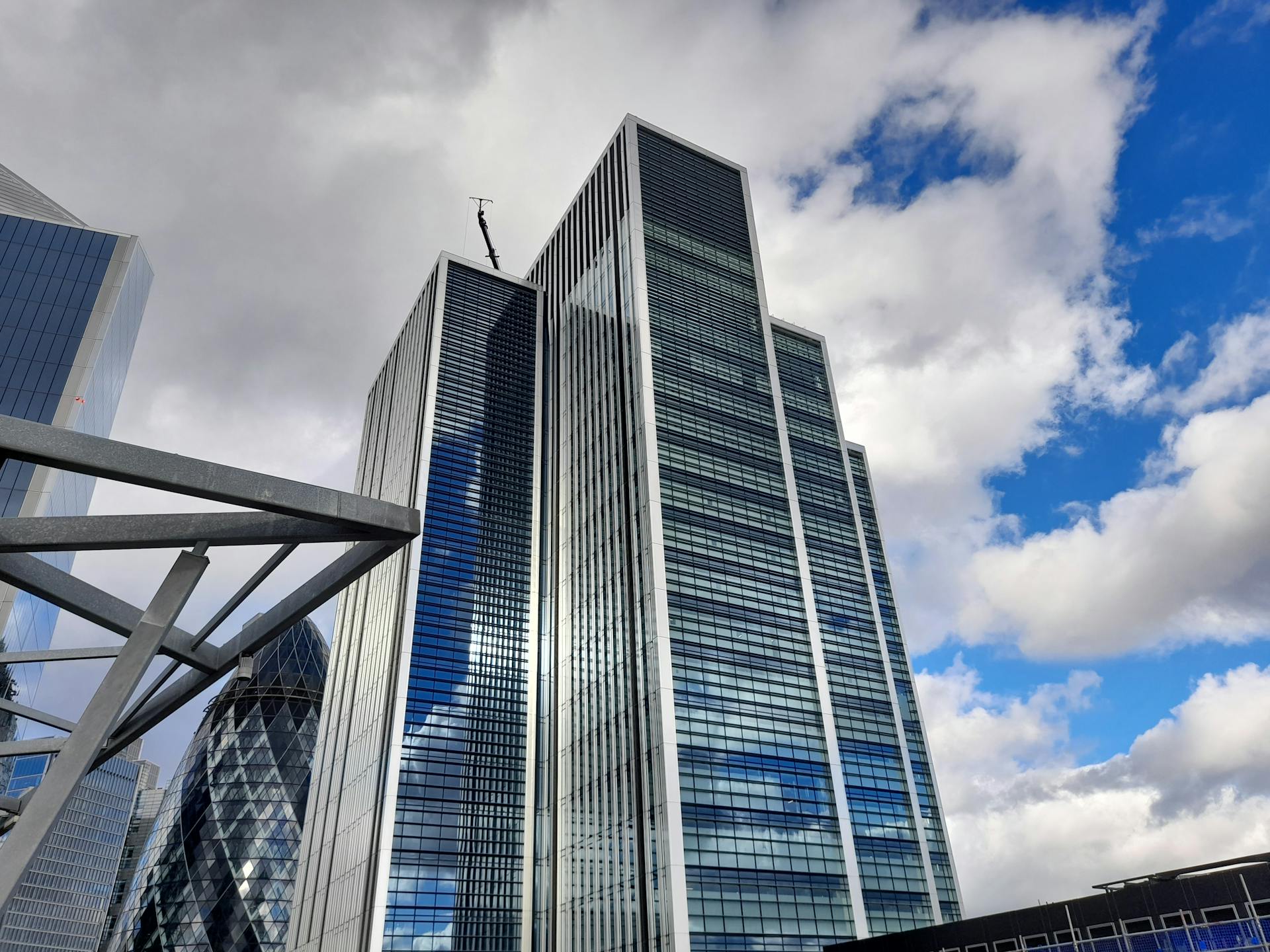 Tall glass skyscrapers against a bright sky in London's financial district, showcasing modern architecture.