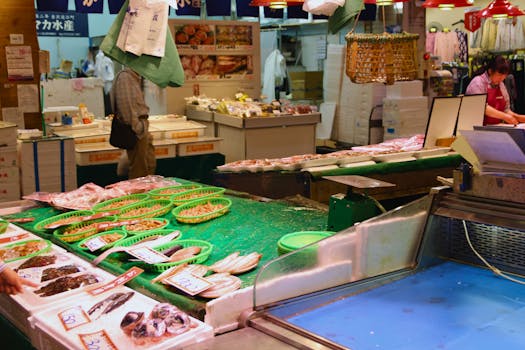 A vibrant fish market in Kanazawa, showcasing various seafood and local market activity.
