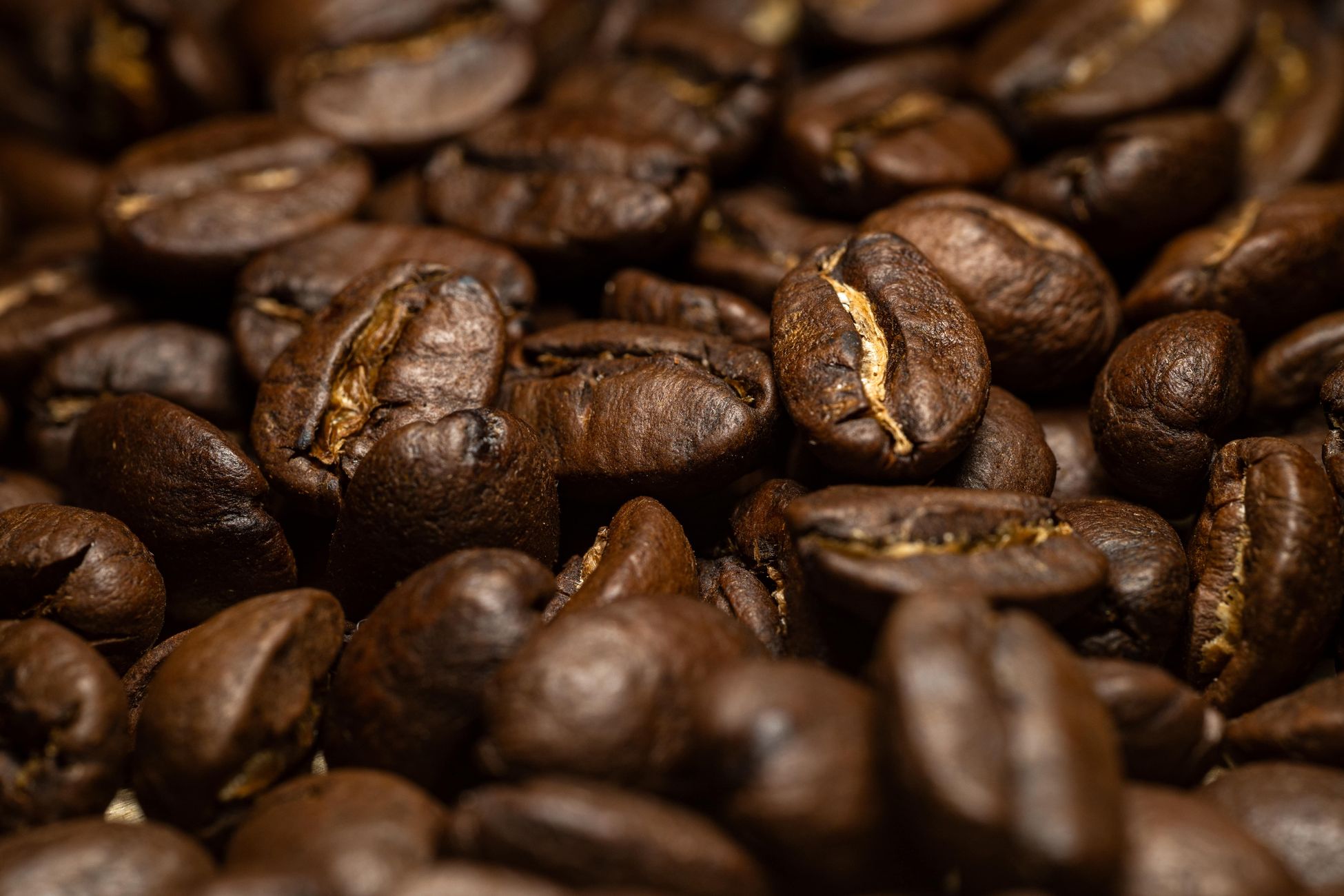 Detailed close-up of aromatic roasted coffee beans, ideal for food and drink themes.