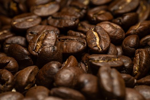 Detailed close-up of aromatic roasted coffee beans, ideal for food and drink themes.