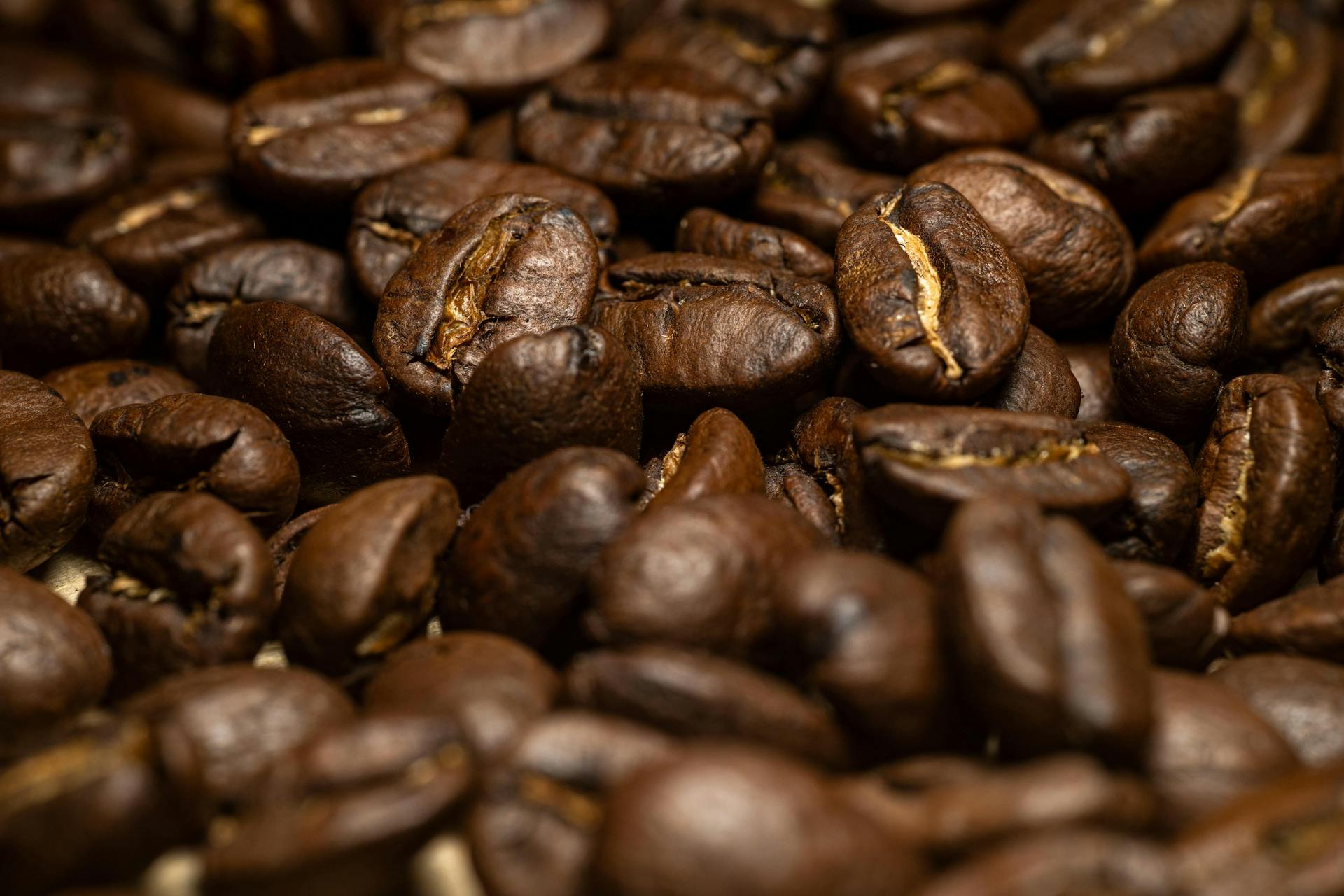 A high-quality close-up of dark roasted coffee beans, perfect for coffee lovers.