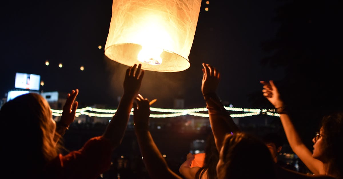 People celebrate by launching a sky lantern at night in Chiang Mai, Thailand.