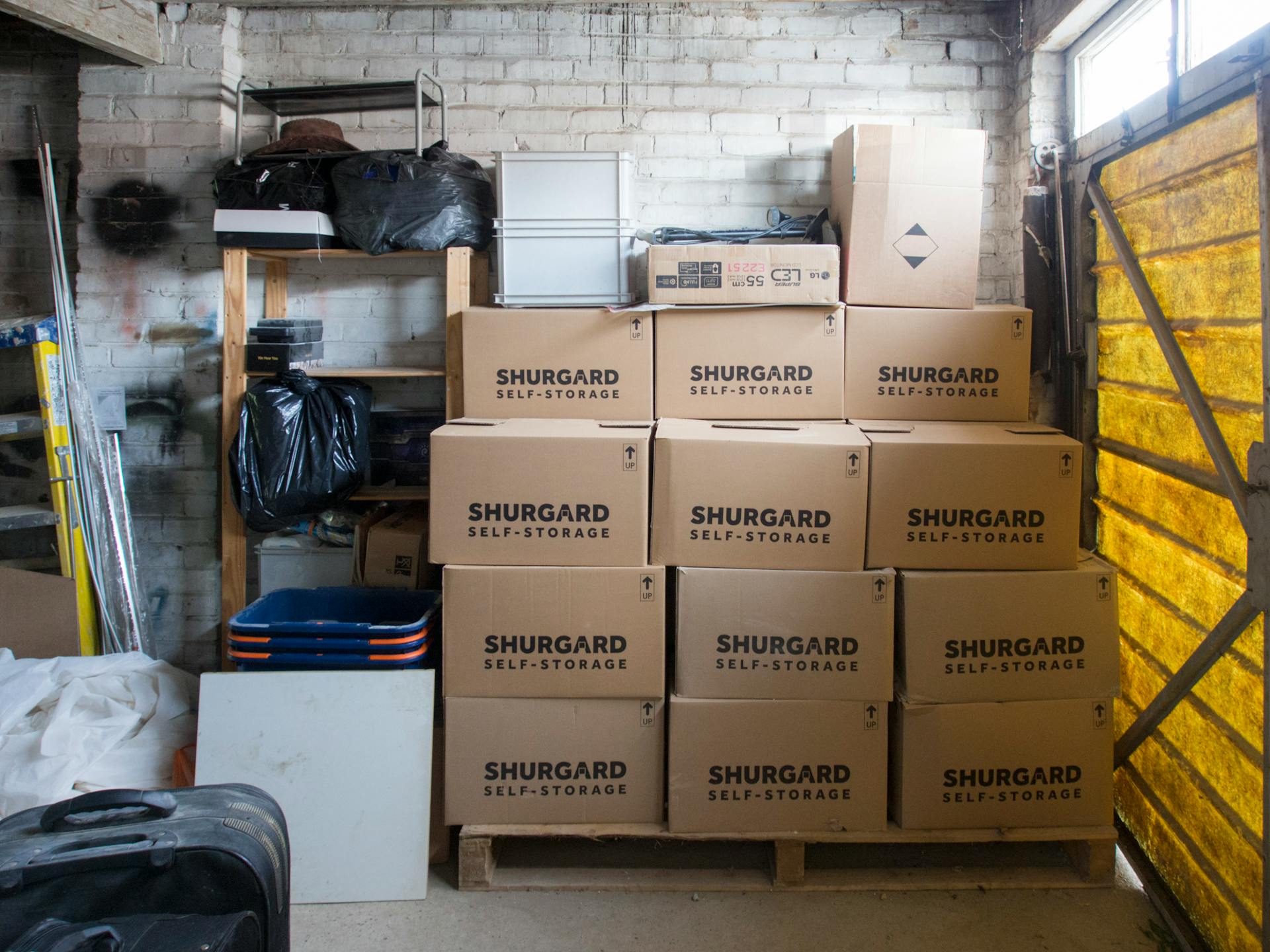 A stack of storage boxes in a well-organized warehouse interior.