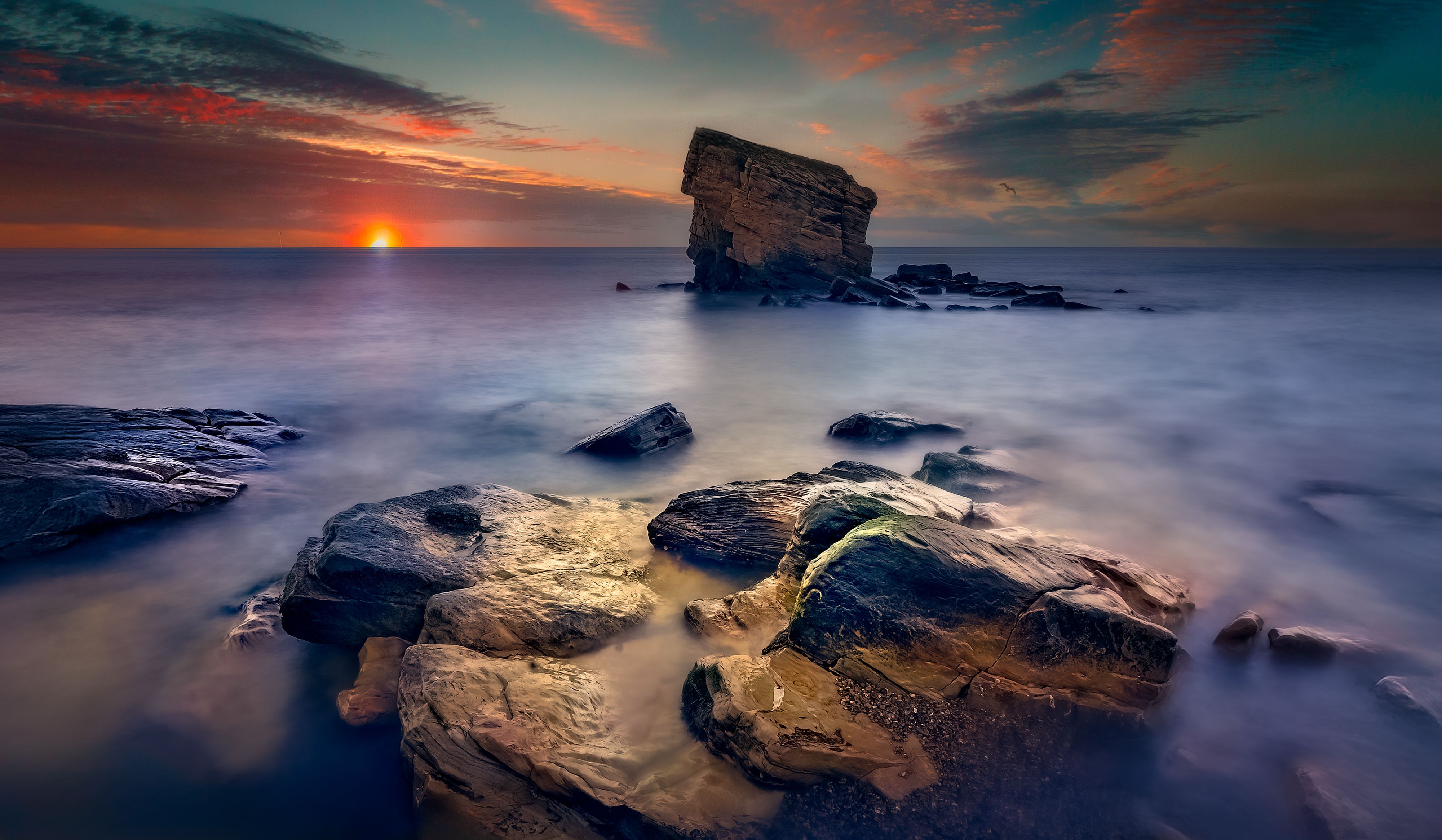 Serene Sunset Over Rocky Seashore with Unique Rock Formation · Free ...