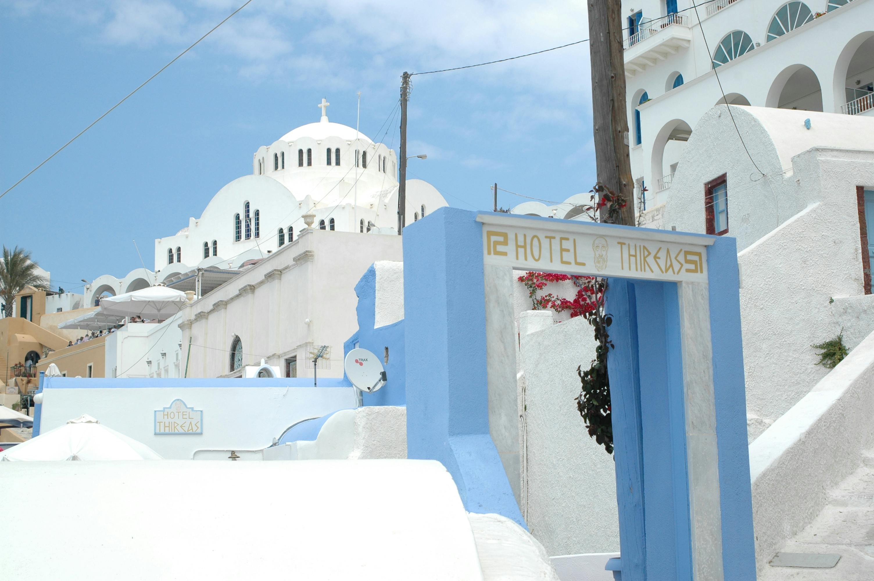 Charming Santorini landscape with classic Greek architecture and Hotel Thira gate.
