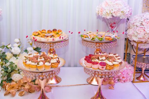 Free Luxurious display of assorted cupcakes and pastries on crystal stands, perfect for an upscale event. Stock Photo