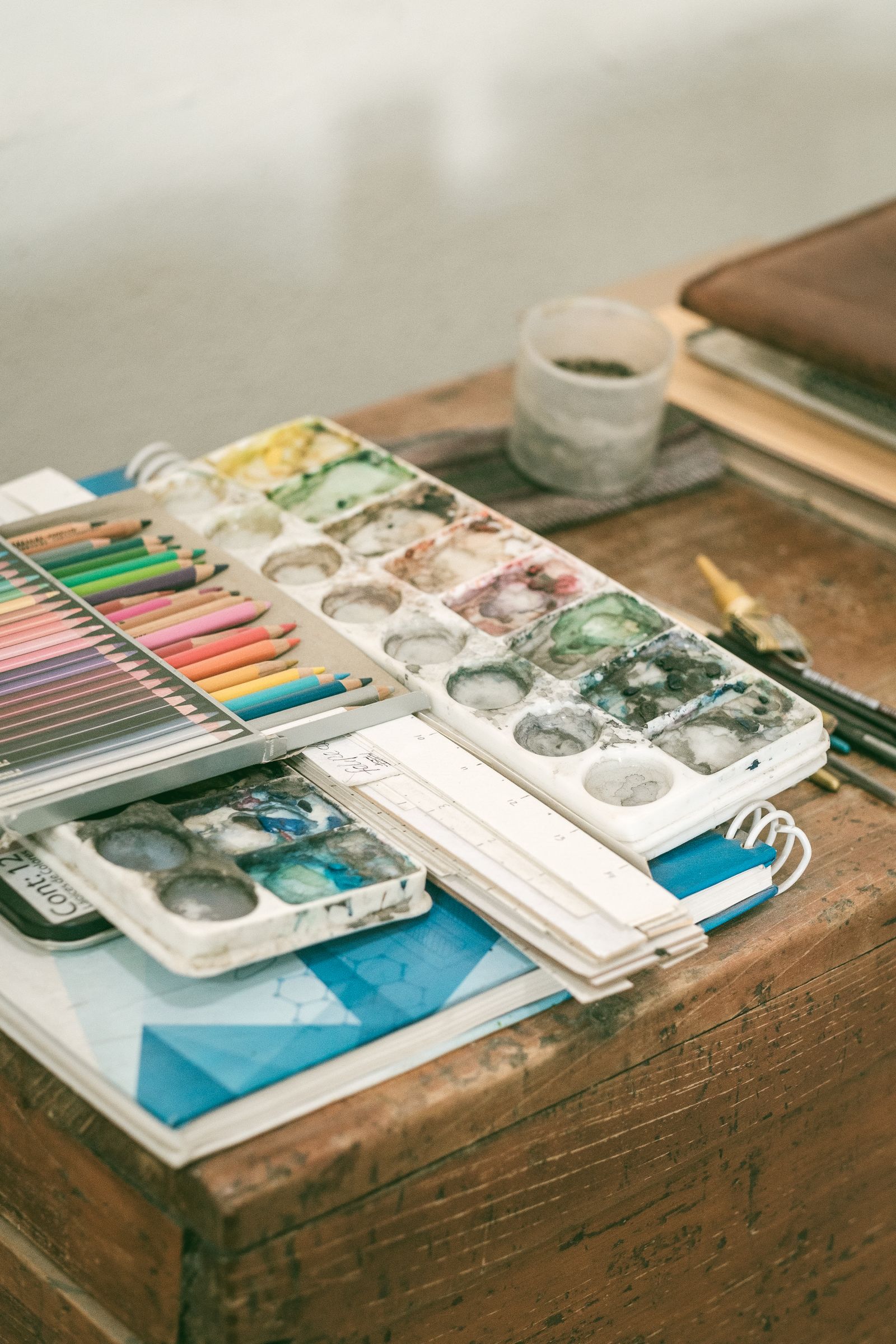 Drawing materials and watercolours on a wooden table