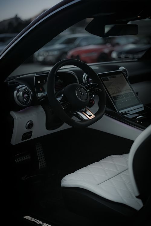 Free Luxurious car interior showcasing leather seats, modern dashboard, and steering wheel. Stock Photo