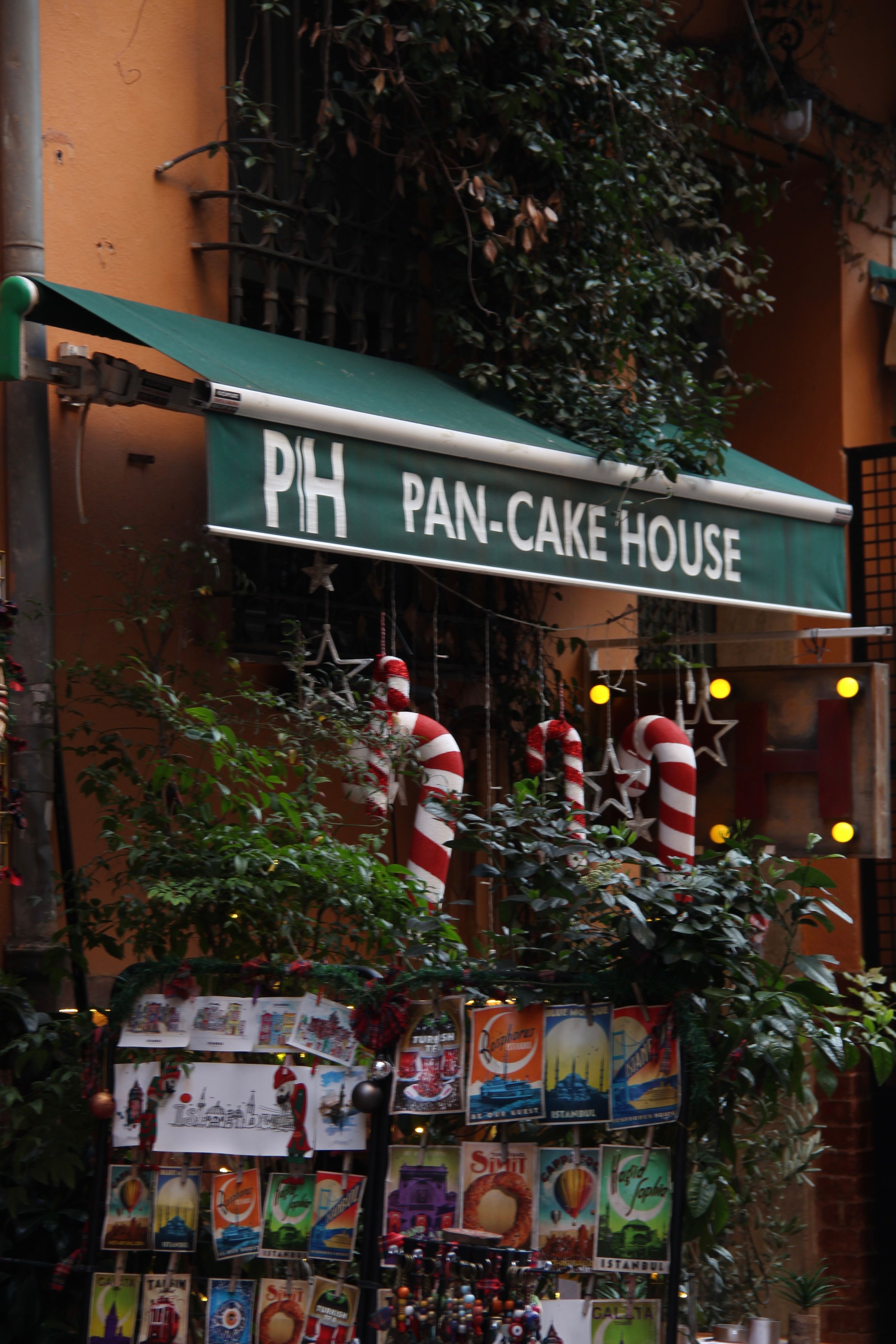 Charming exterior of a pancake house decorated for the holidays with festive lights.