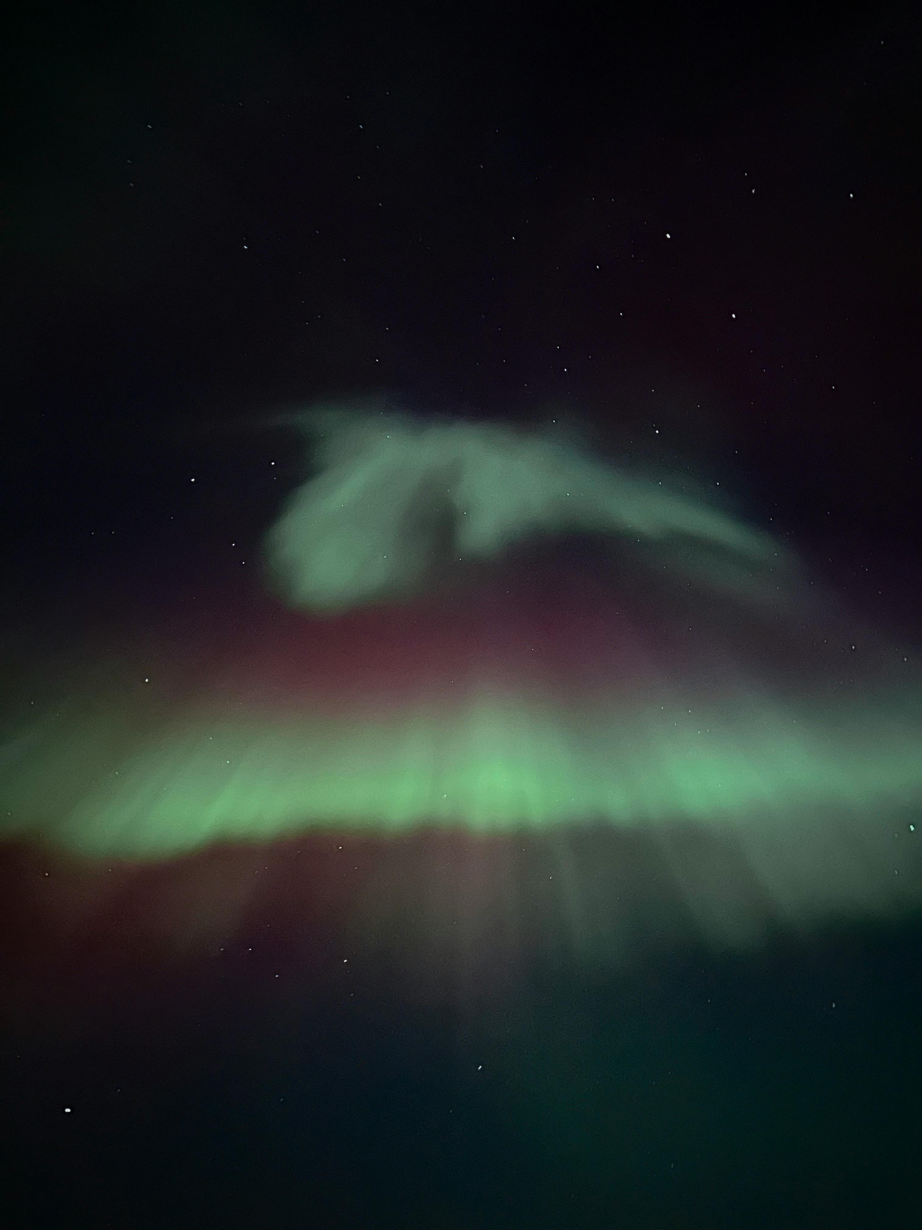 Captivating view of the Northern Lights illuminating the night sky with stars in Canada.