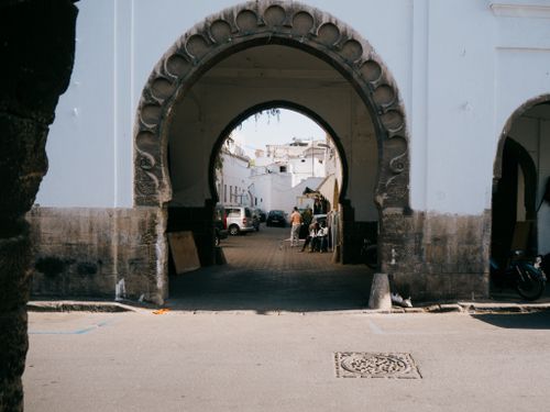 Free Explore a vibrant Moroccan street scene through a historic archway in a bustling city. Stock Photo