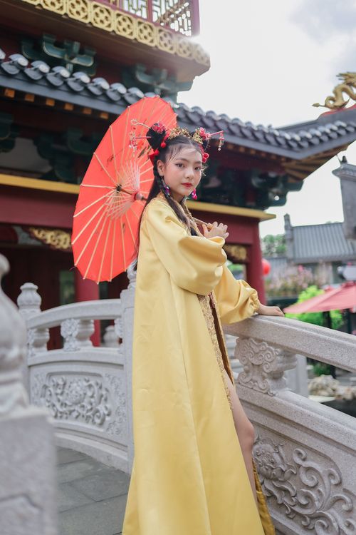 Free Woman in traditional Chinese attire holding parasol at a Jakarta temple. Stock Photo