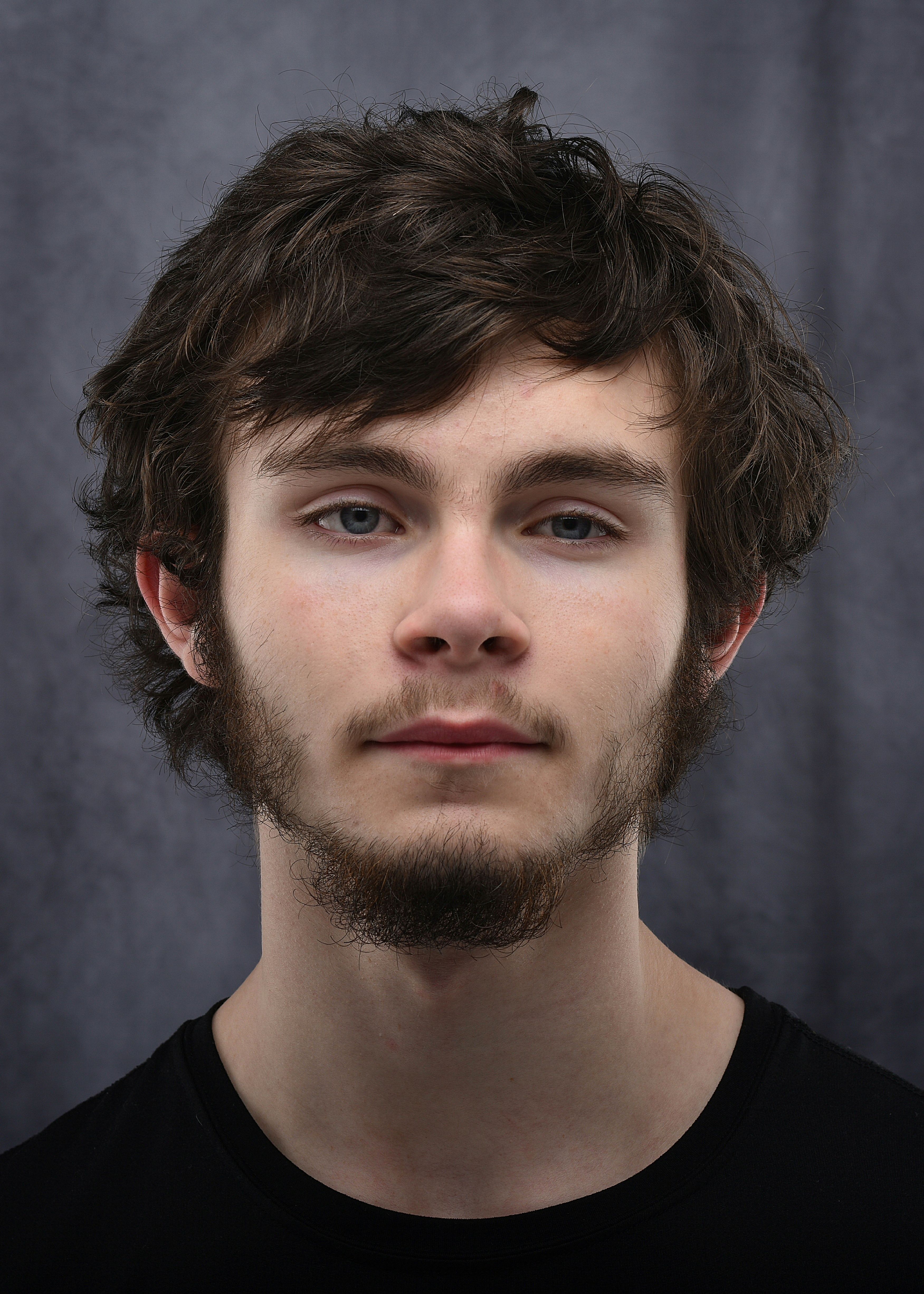 Sam Whitaker photographed against a grey backdrop