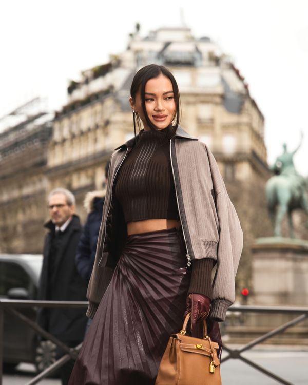 Woman in a pleated skirt with a slim turtleneck