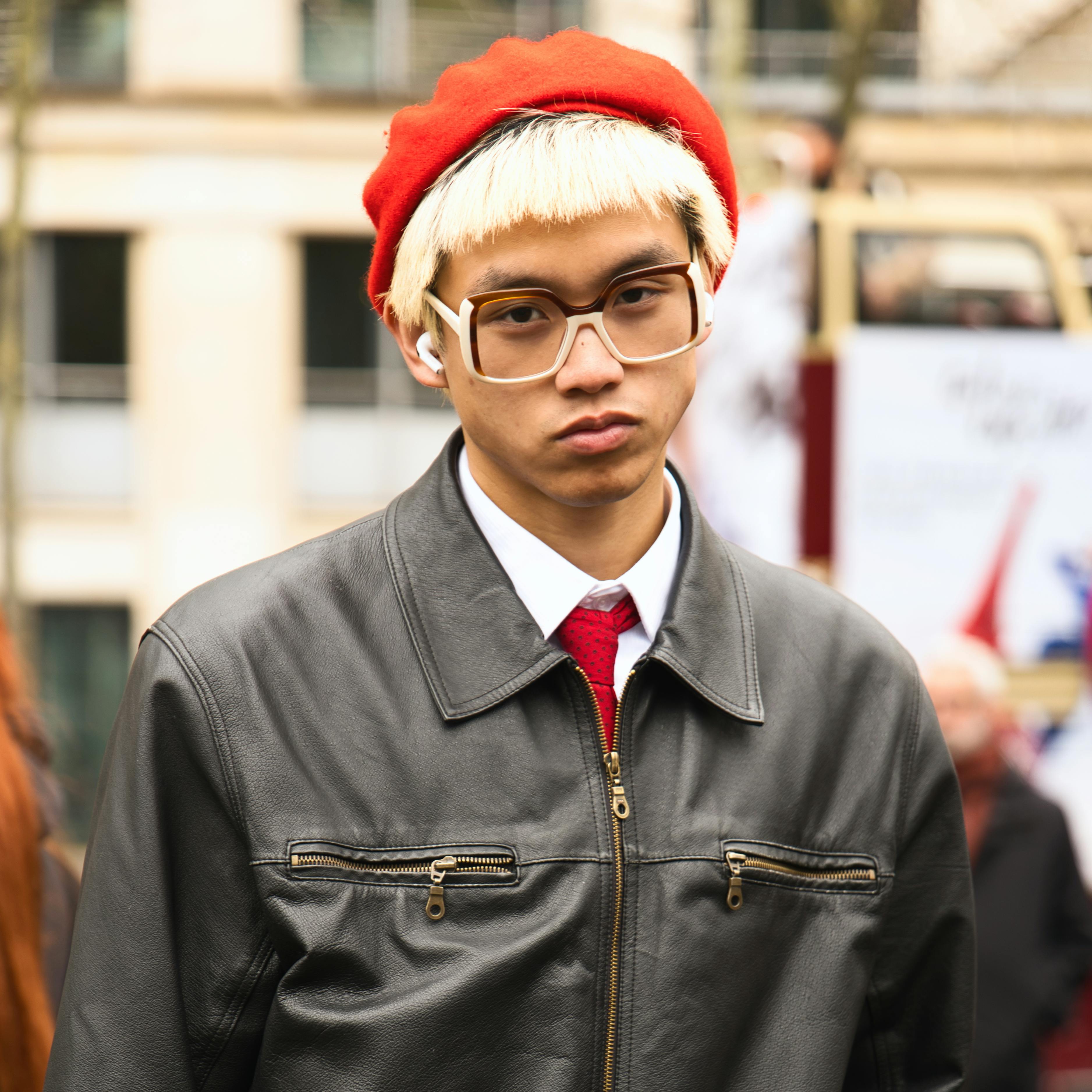 Free Candid street portrait of a stylish youth with vibrant attire in Paris. Stock Photo