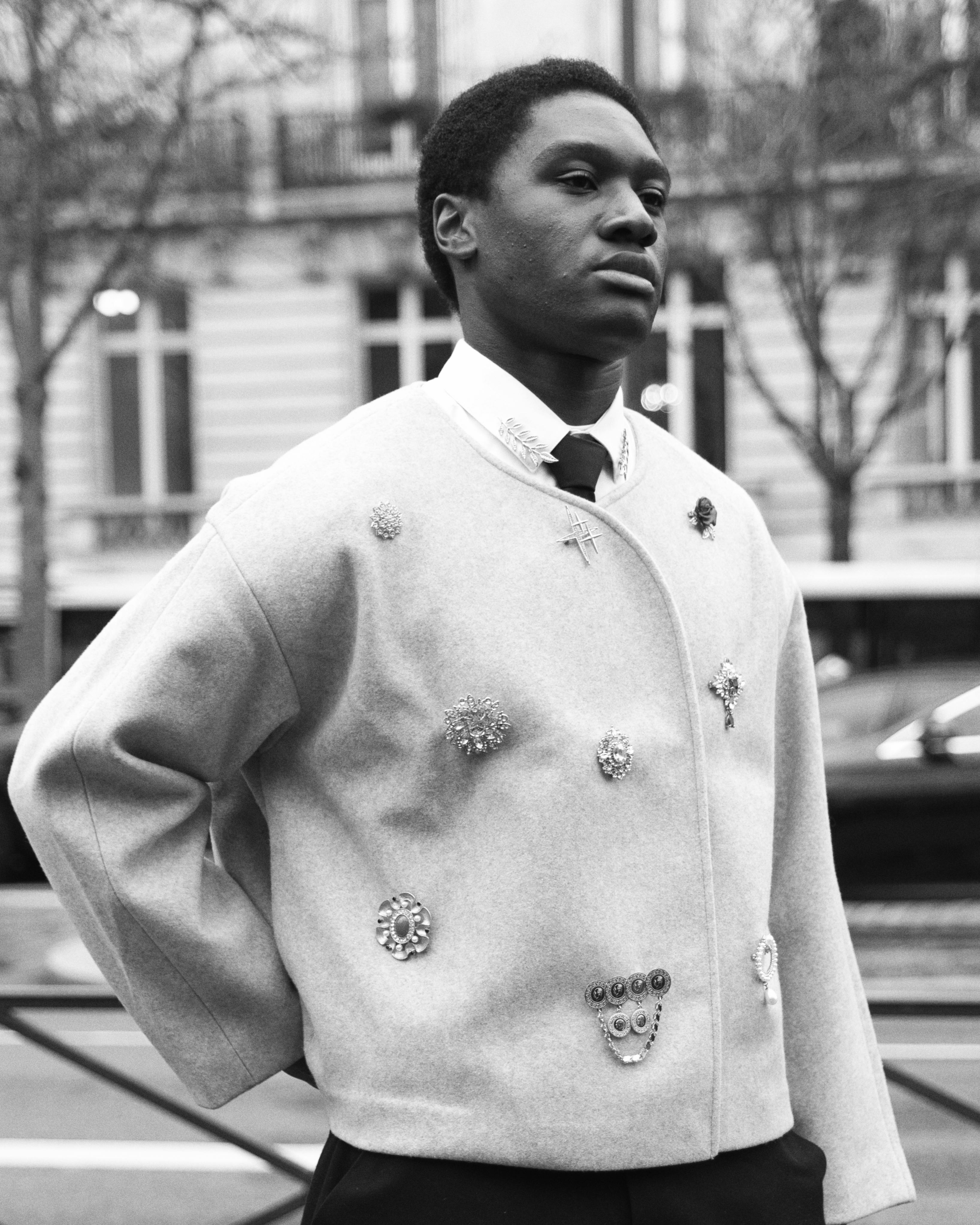 Free Stylish black and white portrait showcasing Parisian fashion on the streets of Paris. Stock Photo